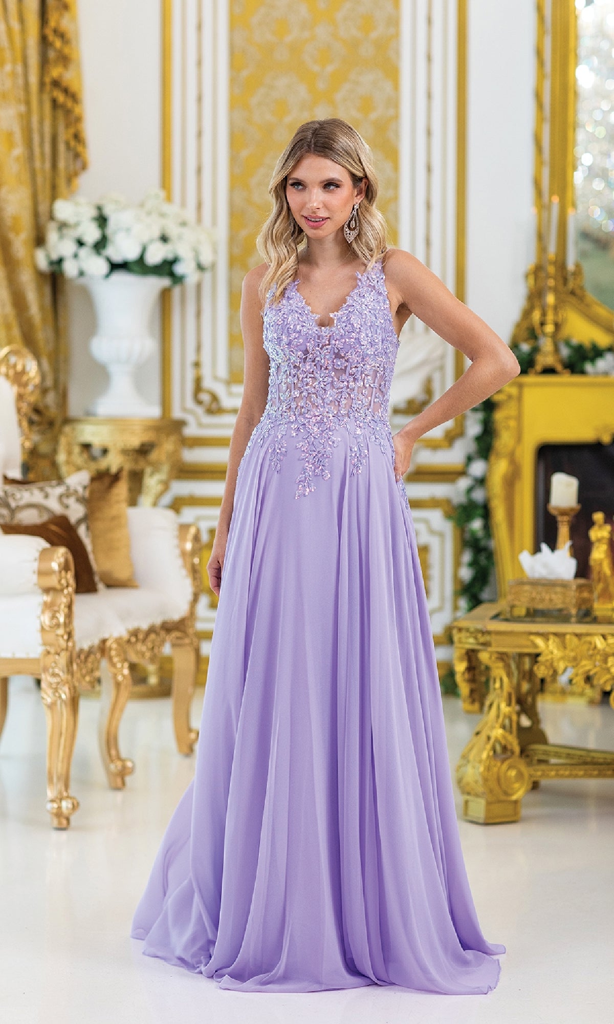 A woman wearing the Lace-Up Long A-Line Prom Dress: Dancing Queen 4446, featuring floral details and a beaded corset, stands in an ornate gold and white room.